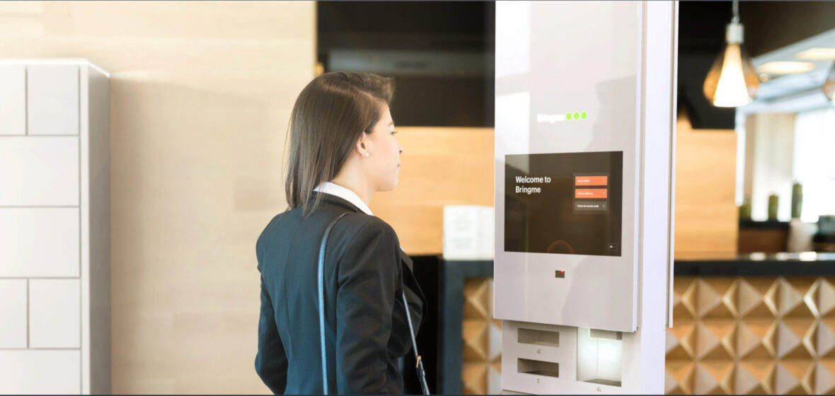 The Millennium Group Virtual reception - woman checking in to office at virtual reception kiosk