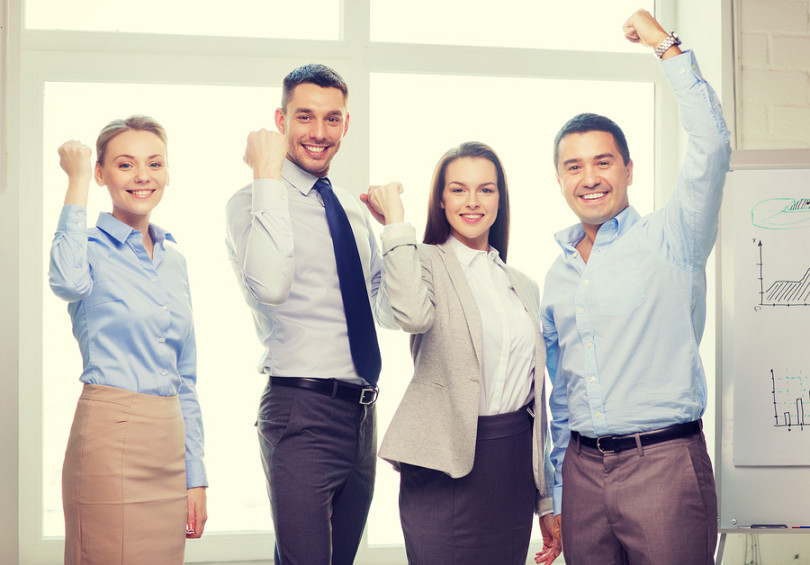 Group of employees working together in office environment