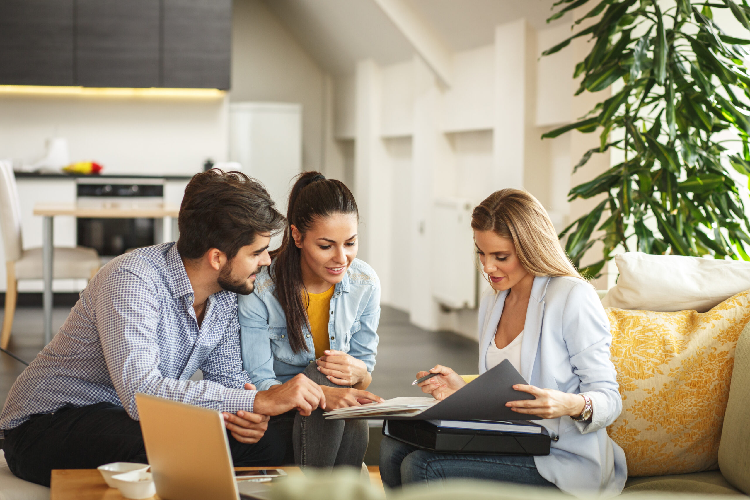 Woman reviewing numbers with young couple