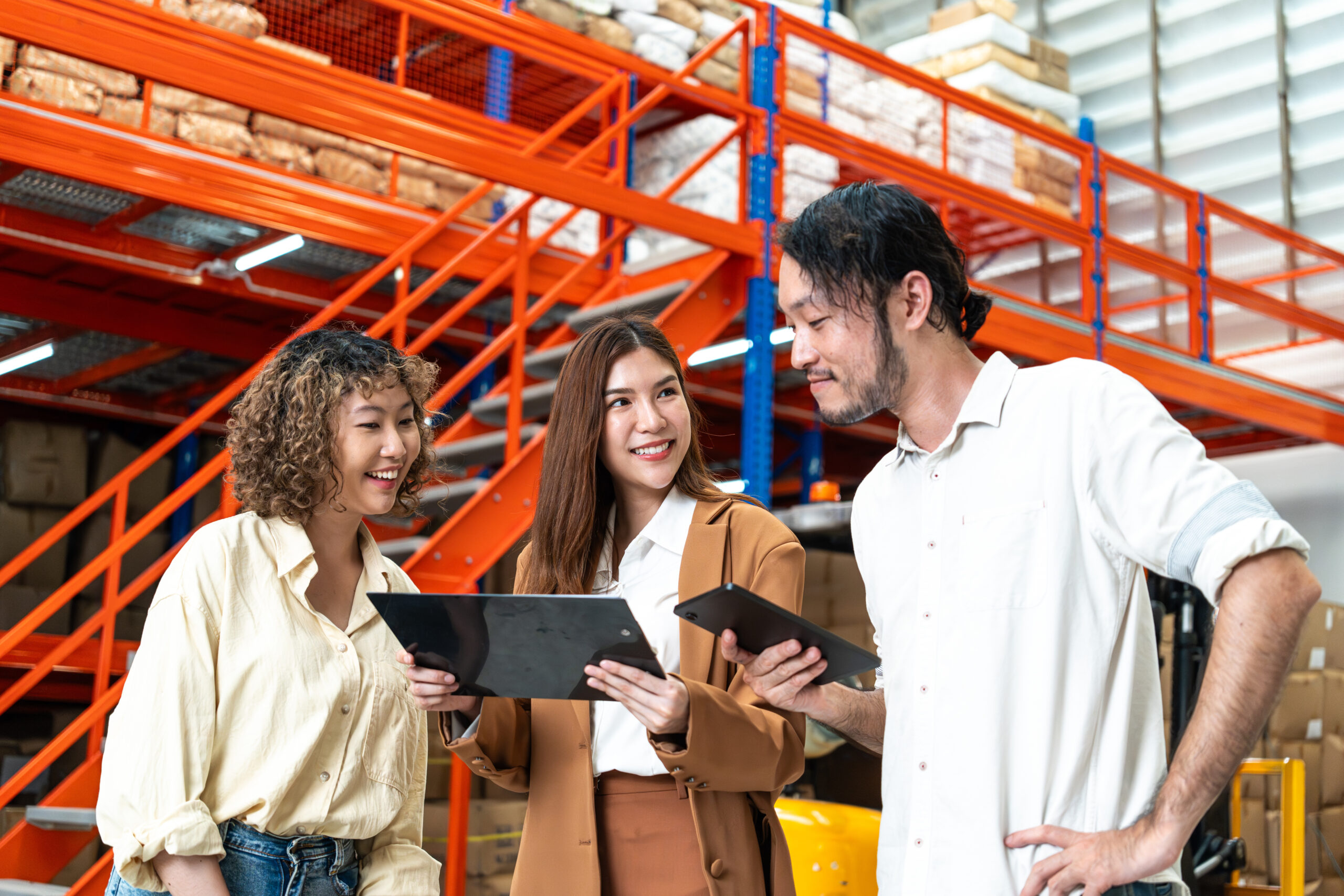 Office workers reviewing information in a warehouse