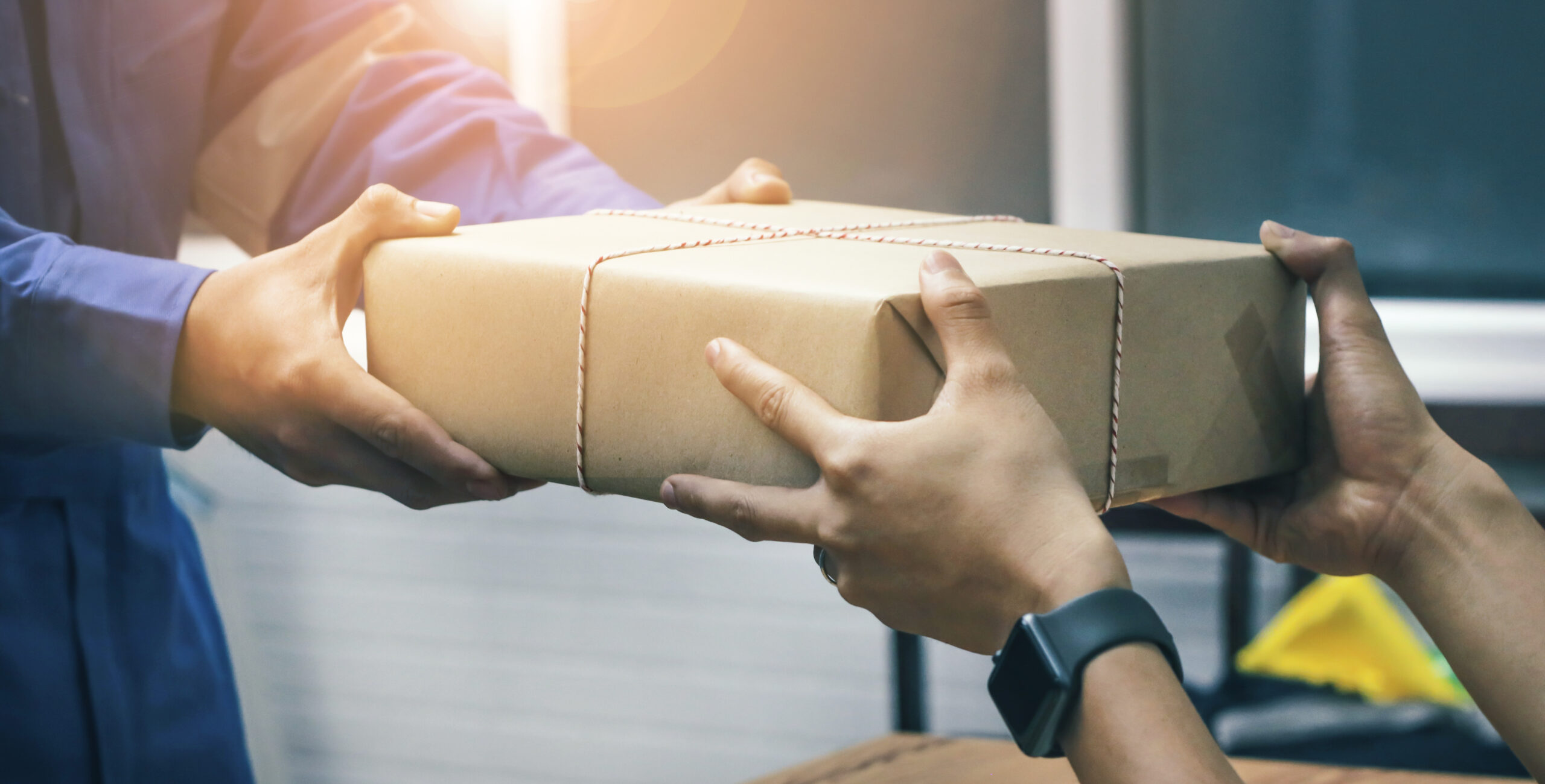 Man handing another man a package